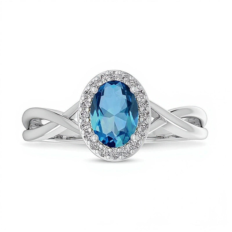Ring mit ovalem Swiss Blue Topas und 0,07 ct. Gesamtgewicht Diamanten mit Rahmen und Crossover-Schiene in 10K Weißgold