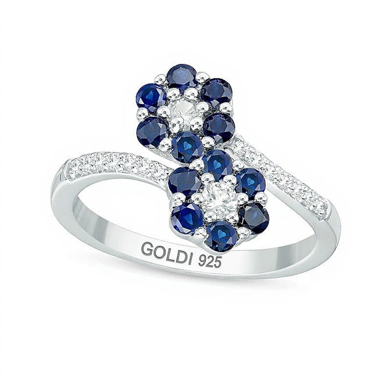Ring mit blauen und weißen Labor-Saphiren, florales Doppelblüten-Bypass-Design in rhodiniertem Sterlingsilber