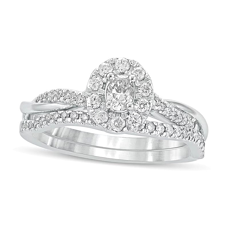 Brautset mit ovalem Diamant 0.5 CT. Gesamtgewicht und gedrehter Ringschiene in 10K Weißgold