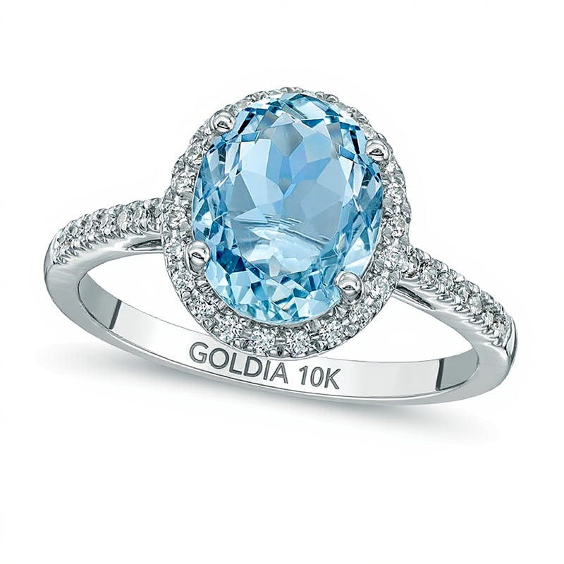 Verlobungsring mit ovalem Aquamarin und 0,2 ct. Gesamtgewicht Diamanten im Halo aus 10K Weißgold
