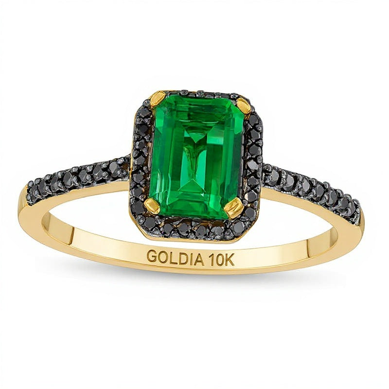 Ring im Smaragdschliff mit Labor-Smaragd und 0,13 ct. Gesamtgewicht schwarzen Diamanten als Halo in 10K Gelbgold