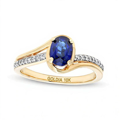 Solitär mit seitlichem Besatz mit ovalem blauem Labor-Saphir und 0.1 ct. Gesamtgewicht Diamant in 10K Gelbgold