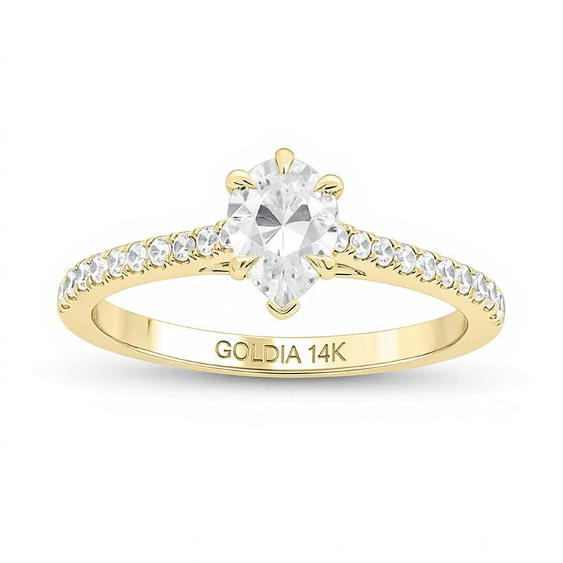 0,75 ct. Gesamtgewicht Solitär mit seitlichem Besatz mit Diamanten in Tropfen- und Rundschliff in 14K Gelbgold (I/I2)