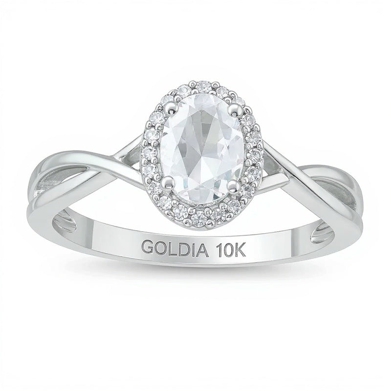 Ring mit ovalem Aquamarin und 0,07 ct. Gesamtgewicht Diamanten, Halo und gedrehter Ringschiene in 10K Weißgold