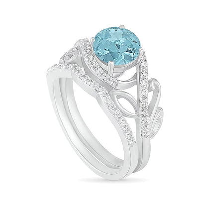 7,0 mm Aquamarin und 0,38 ct. Gesamtgewicht Diamant Bypass Brautset mit Blattdesign-Ringschiene in 10K Weißgold